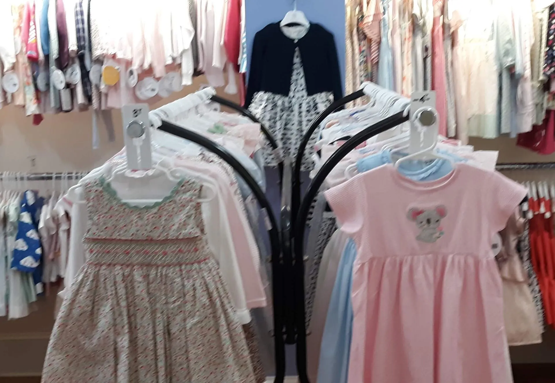 A display of children 's clothes in a store.