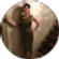 A woman is standing in a circle with her hands on her hips.